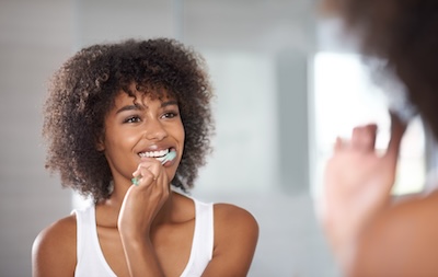 woman brushing teeth